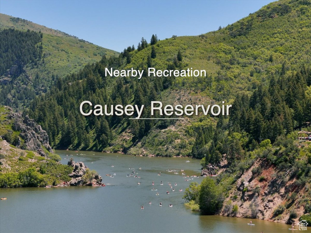 Water view with a heavily wooded area and mountains