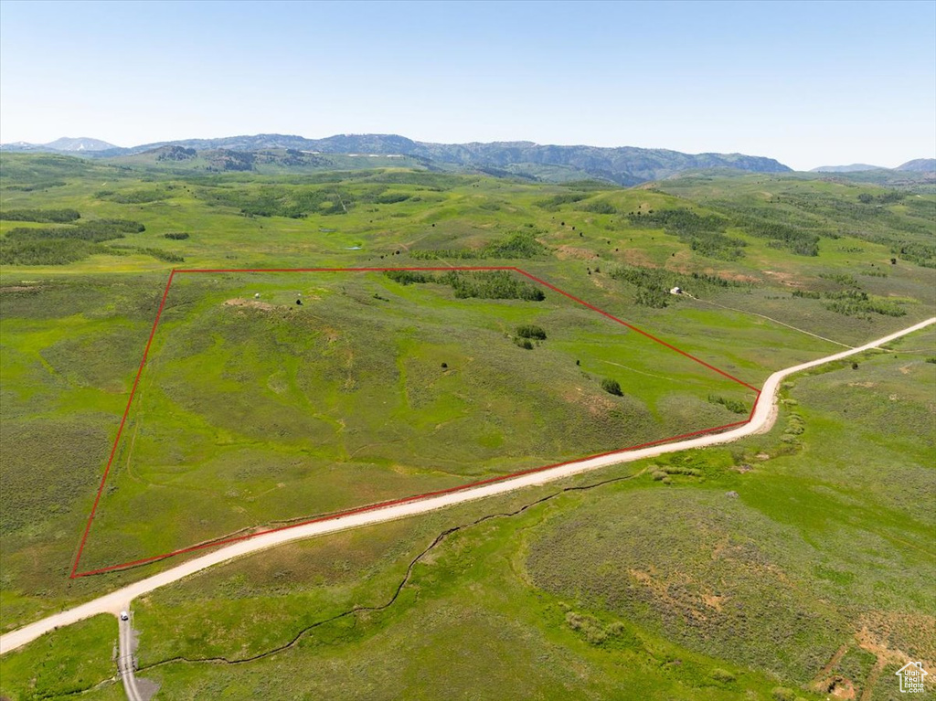 Overview of rural landscape with property parcel outlined and mountains
