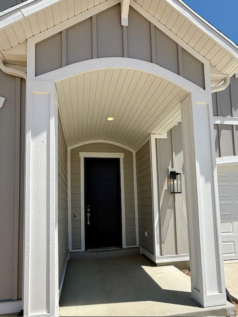 Doorway to property featuring board and batten siding