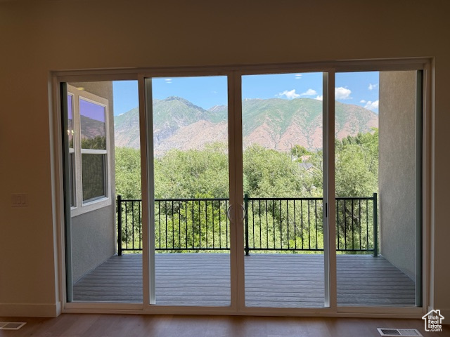 Doorway featuring baseboards, wood finished floors, and a mountain view