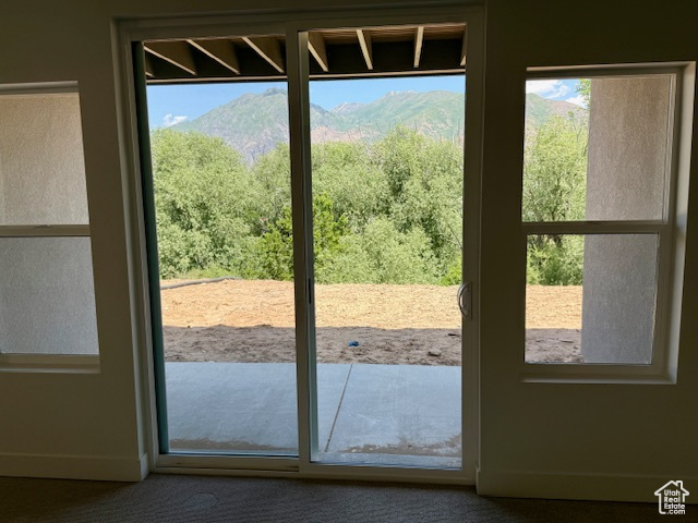 Entryway with a mountain view and carpet