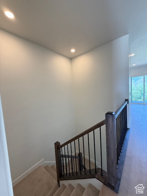 Stairway with recessed lighting and baseboards