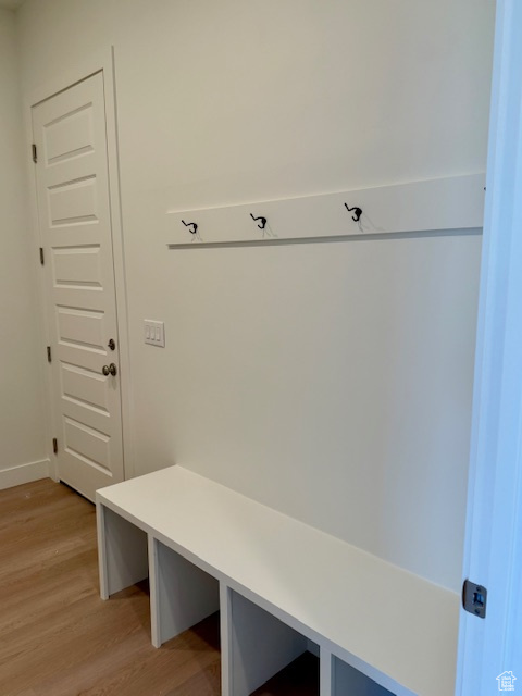 Mudroom featuring light wood-type flooring and baseboards