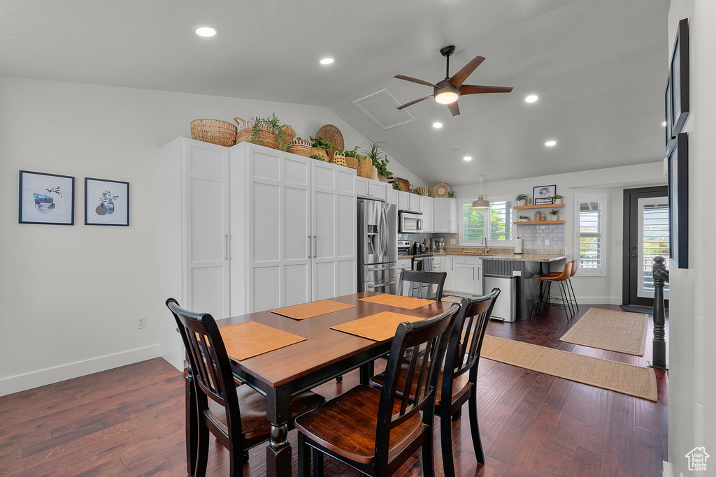 Dining space with ceiling fan, recessed lighting, dark wood finished floors, baseboards, and high vaulted ceiling