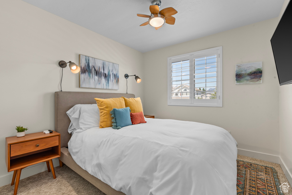 Bedroom with carpet floors, baseboards, and ceiling fan