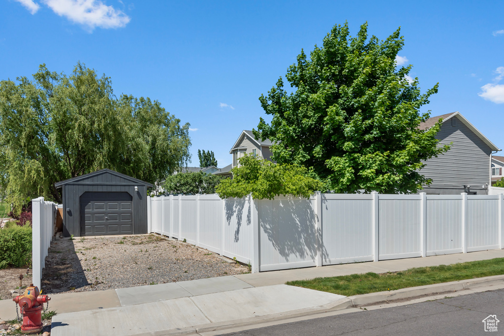 Exterior space with an outbuilding and a garage