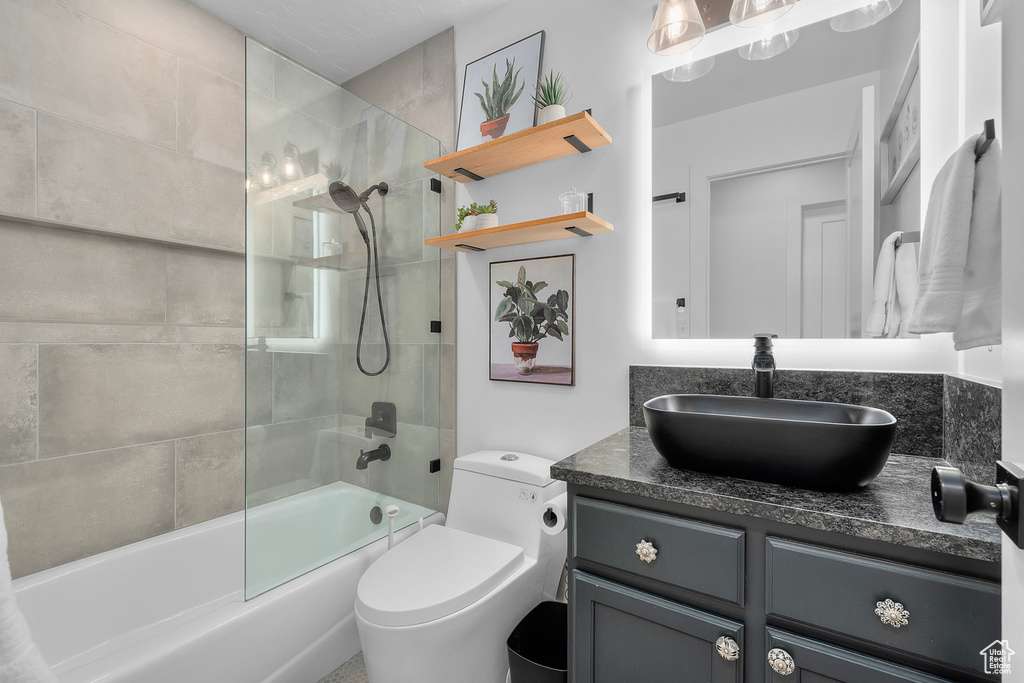 Bathroom with vanity, shower / washtub combination, and toilet