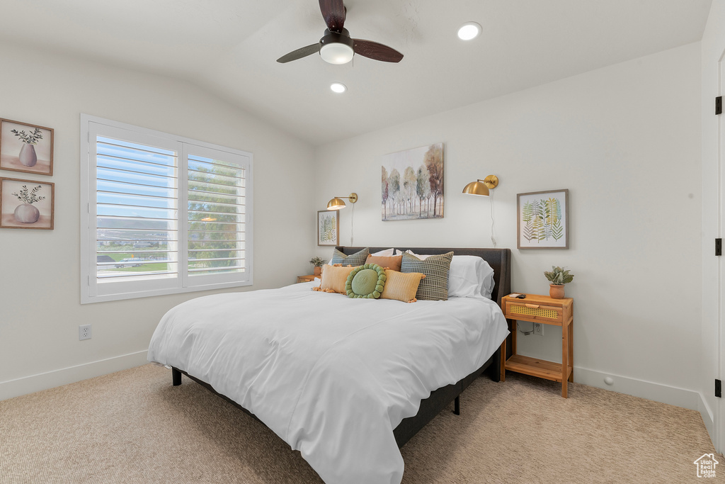 Bedroom with lofted ceiling, carpet floors, baseboards, recessed lighting, and a ceiling fan