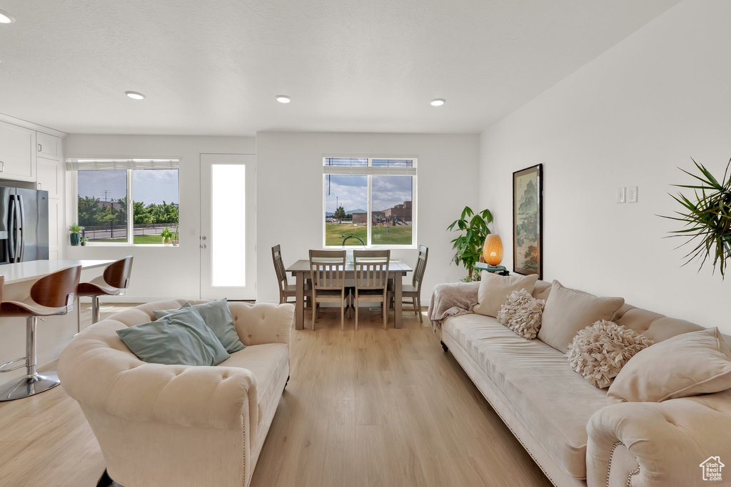 Living room featuring light wood finished floors and recessed lighting