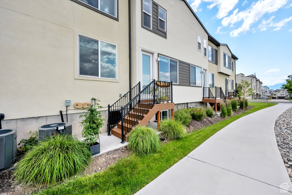 View of property featuring a residential view and cooling unit