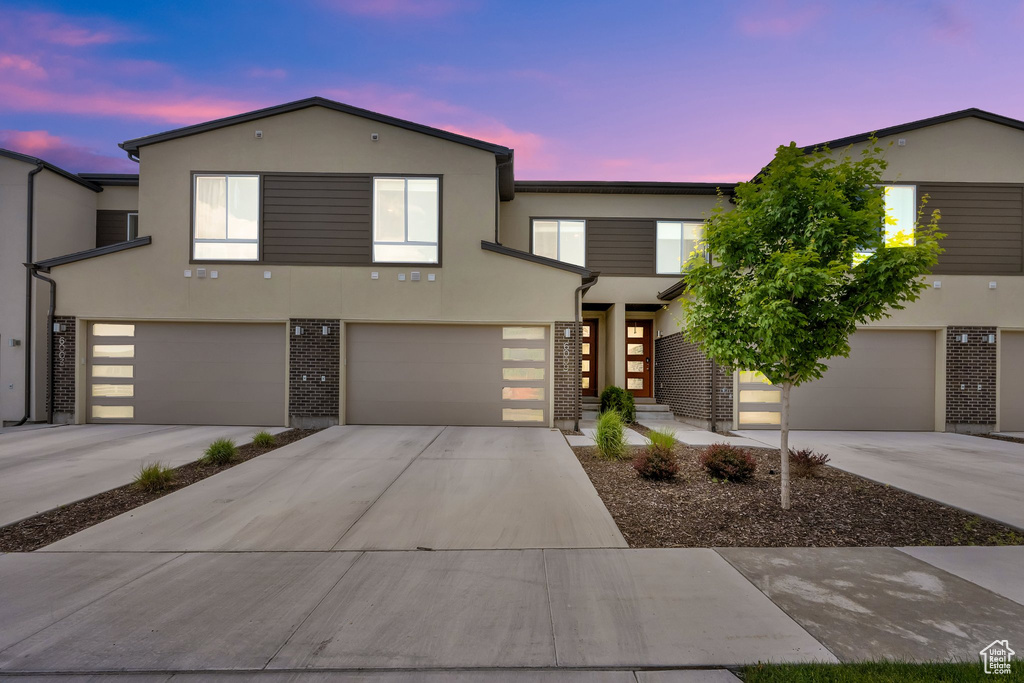 View of front of home with stucco siding and brick siding