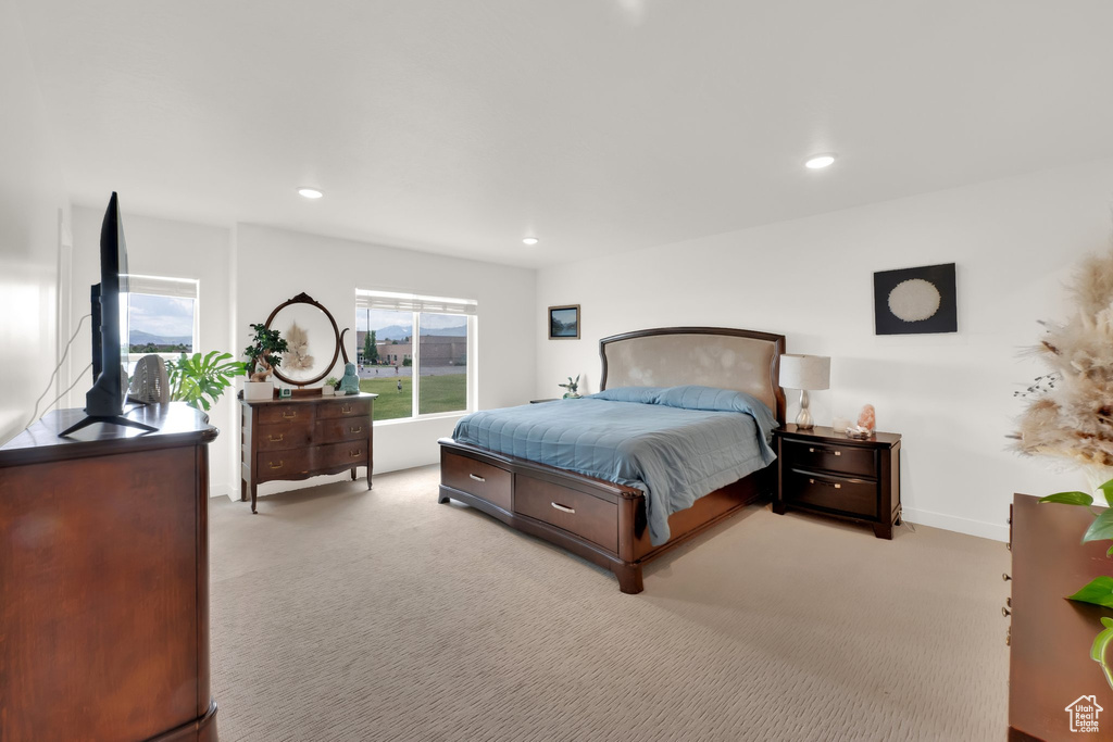 Bedroom with light colored carpet and recessed lighting