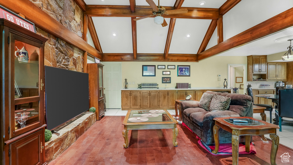Living area featuring ceiling fan, high vaulted ceiling, beamed ceiling, and recessed lighting