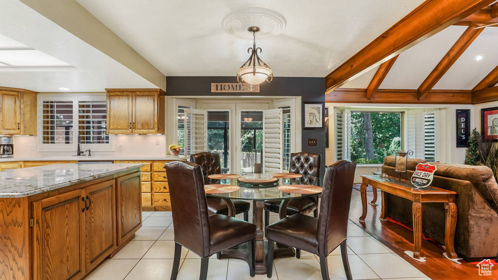 Dining room with light tile patterned floors and recessed lighting