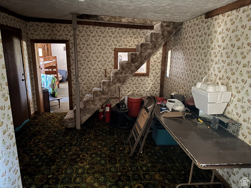 Miscellaneous room featuring wallpapered walls and stairs