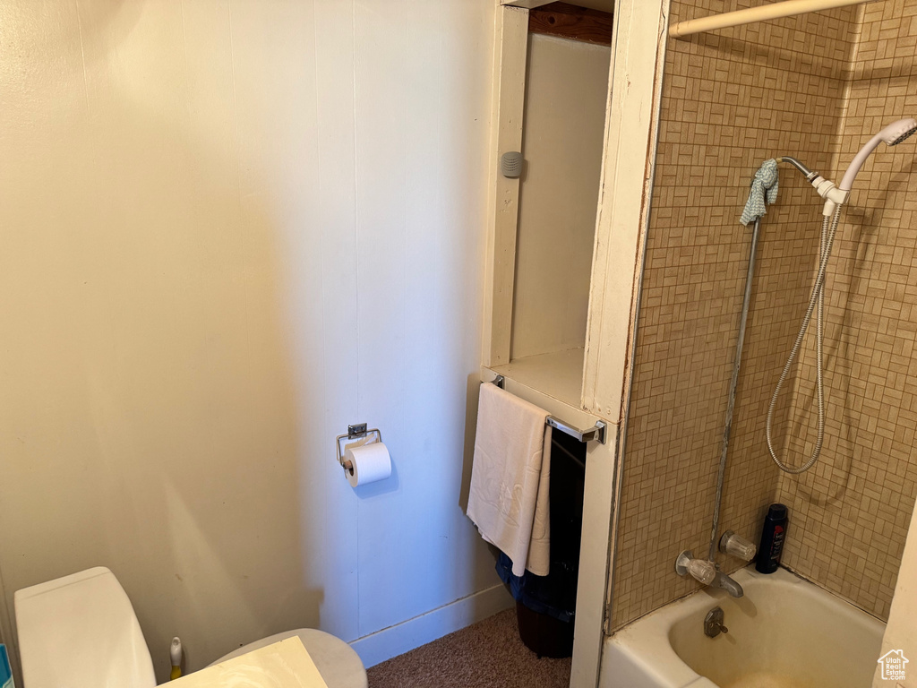 Full bathroom with toilet and bathing tub / shower combination