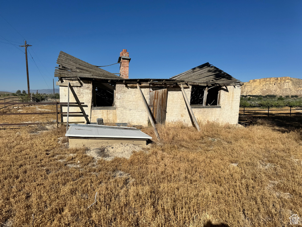 Back of property with a chimney