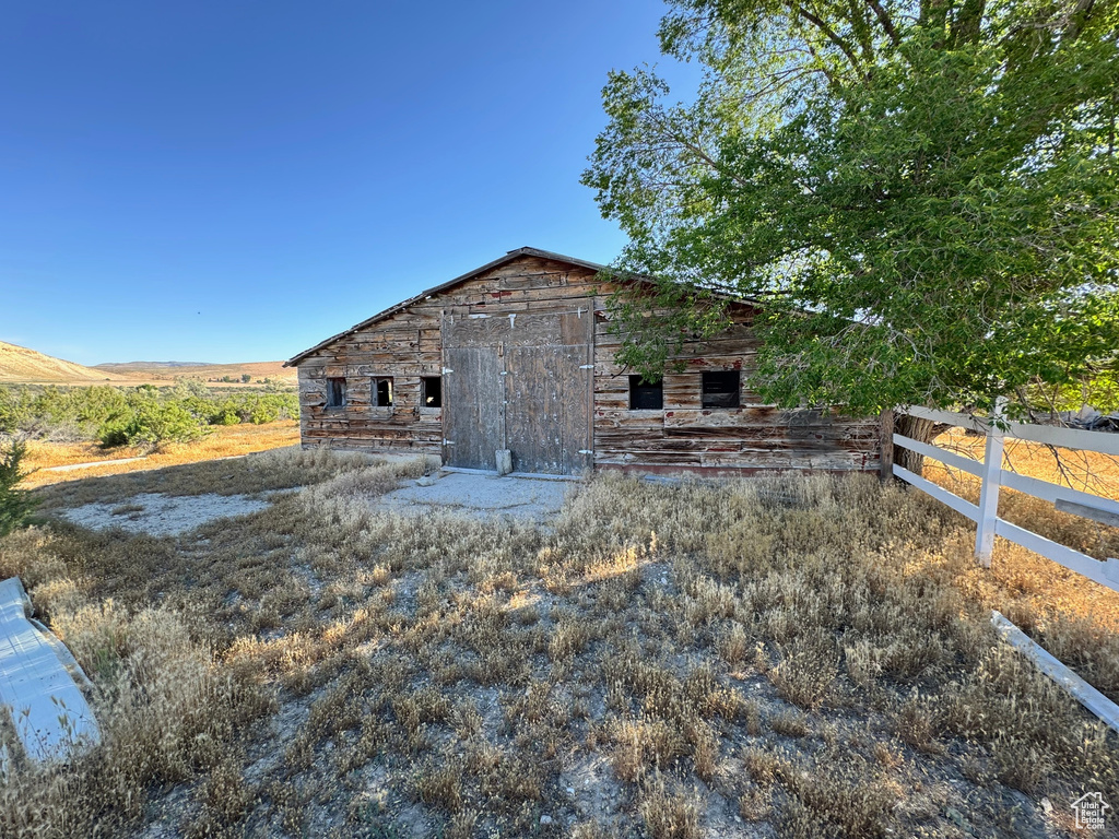View of side of property with a barn and an outbuilding
