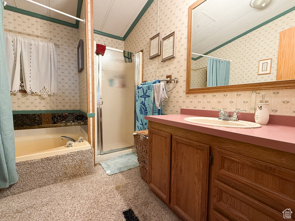 Full bath with wallpapered walls, a shower stall, crown molding, vanity, and a garden tub