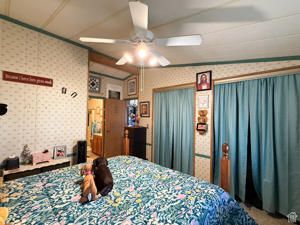 Bedroom featuring wallpapered walls and ceiling fan