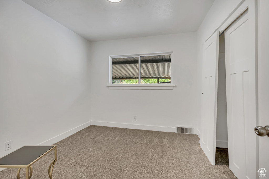 Unfurnished bedroom featuring carpet flooring and baseboards