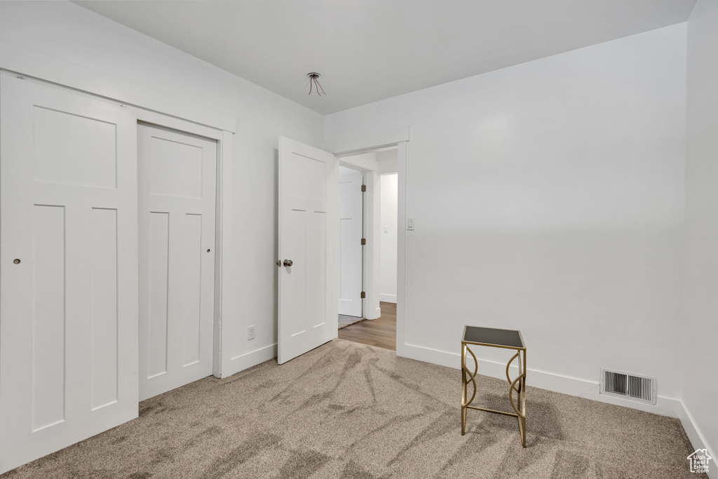Unfurnished bedroom featuring carpet floors and baseboards
