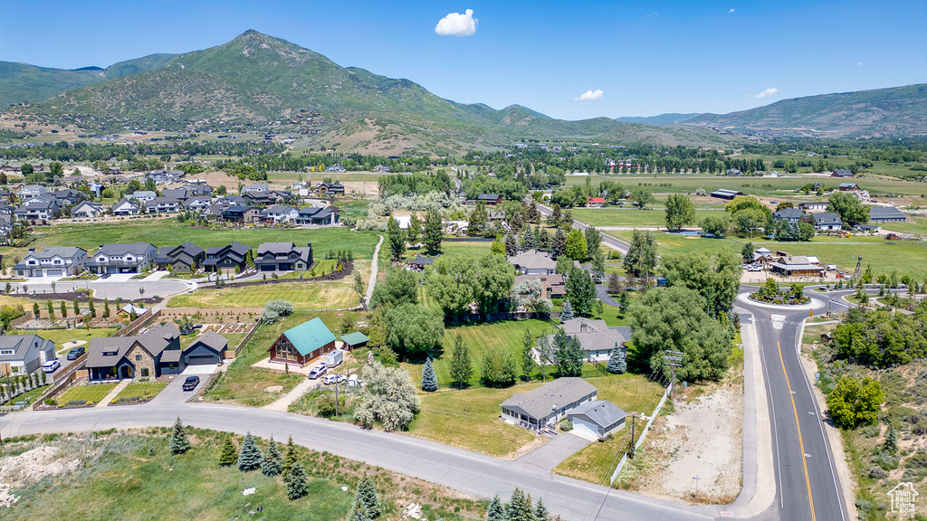 Aerial overview of property\'s location featuring nearby suburban area and mountains