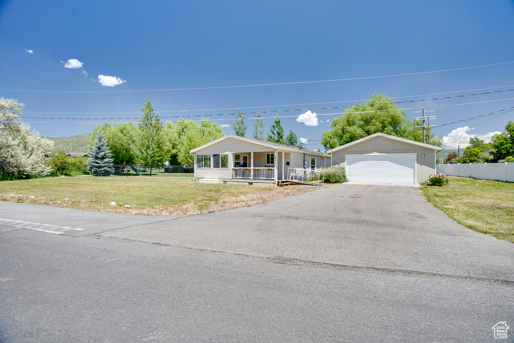 Ranch-style home with a porch and a detached garage