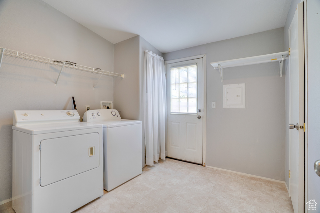 Laundry room featuring washing machine and dryer and baseboards