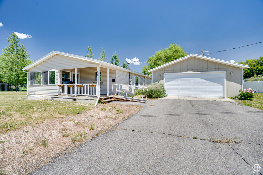 Ranch-style house featuring a garage, a porch, and crawl space