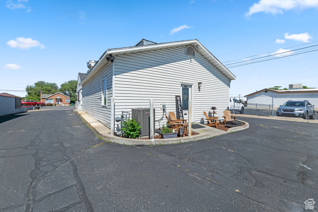 View of side of home featuring cooling unit