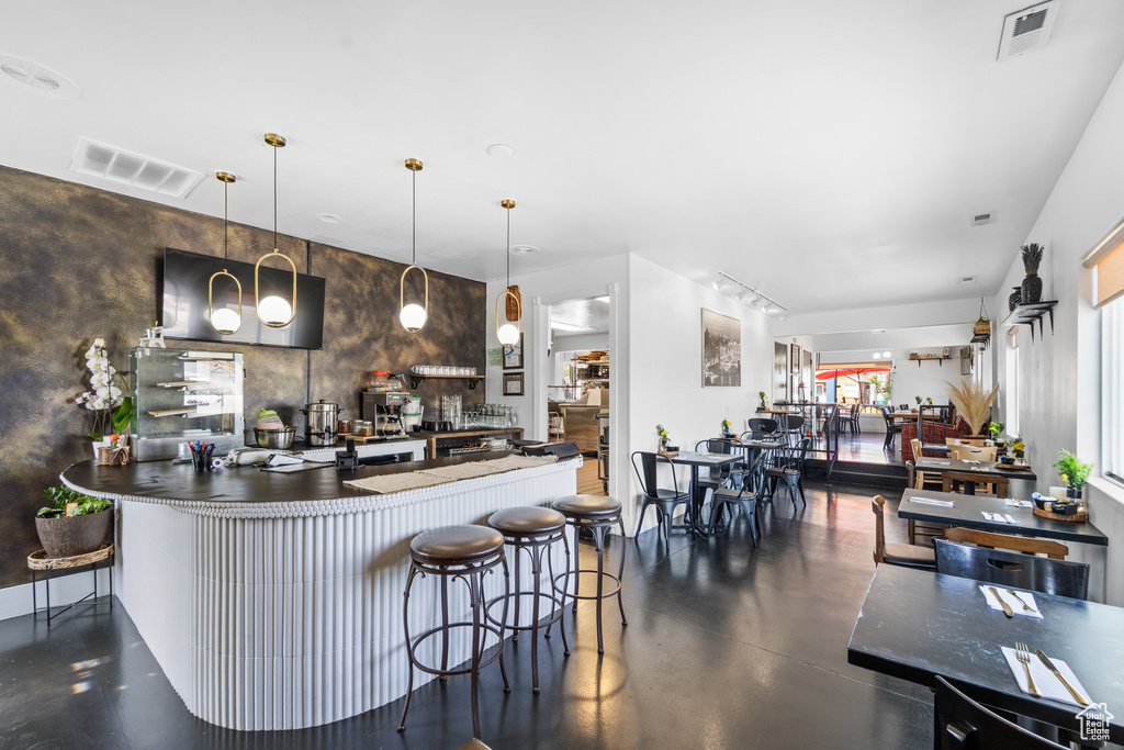 Kitchen with concrete flooring and decorative light fixtures