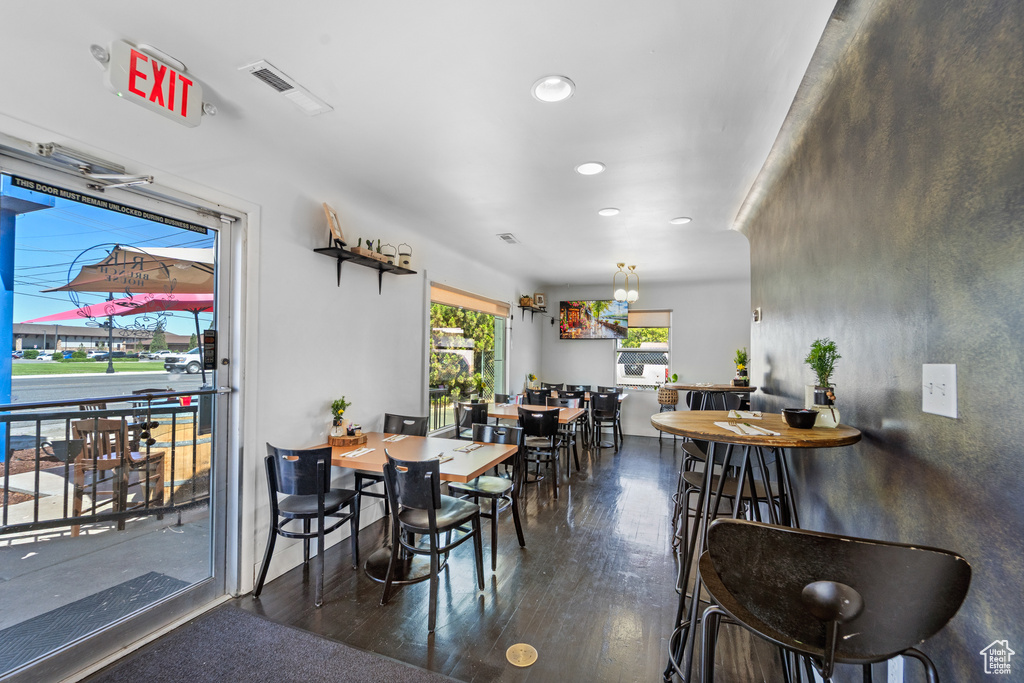 Dining space with wood finished floors and recessed lighting