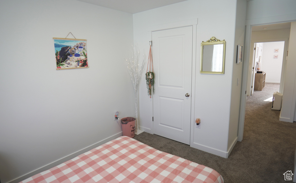 Carpeted bedroom with baseboards