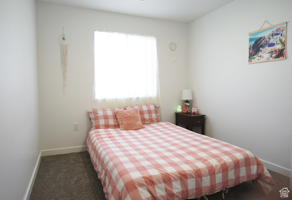 Bedroom featuring baseboards and carpet floors