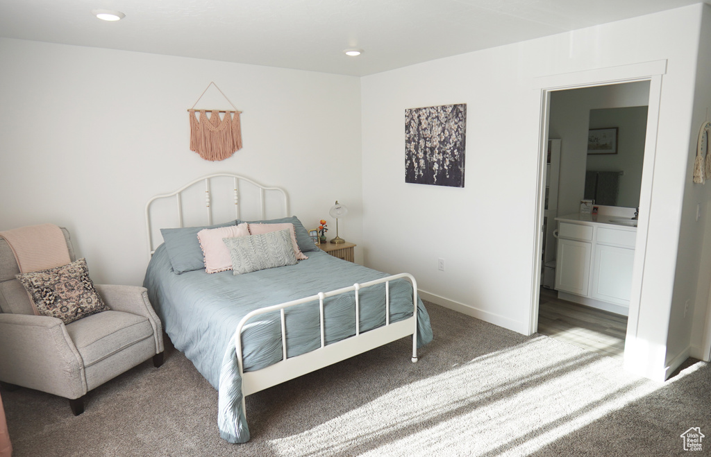 Carpeted bedroom featuring ensuite bath, baseboards, and recessed lighting