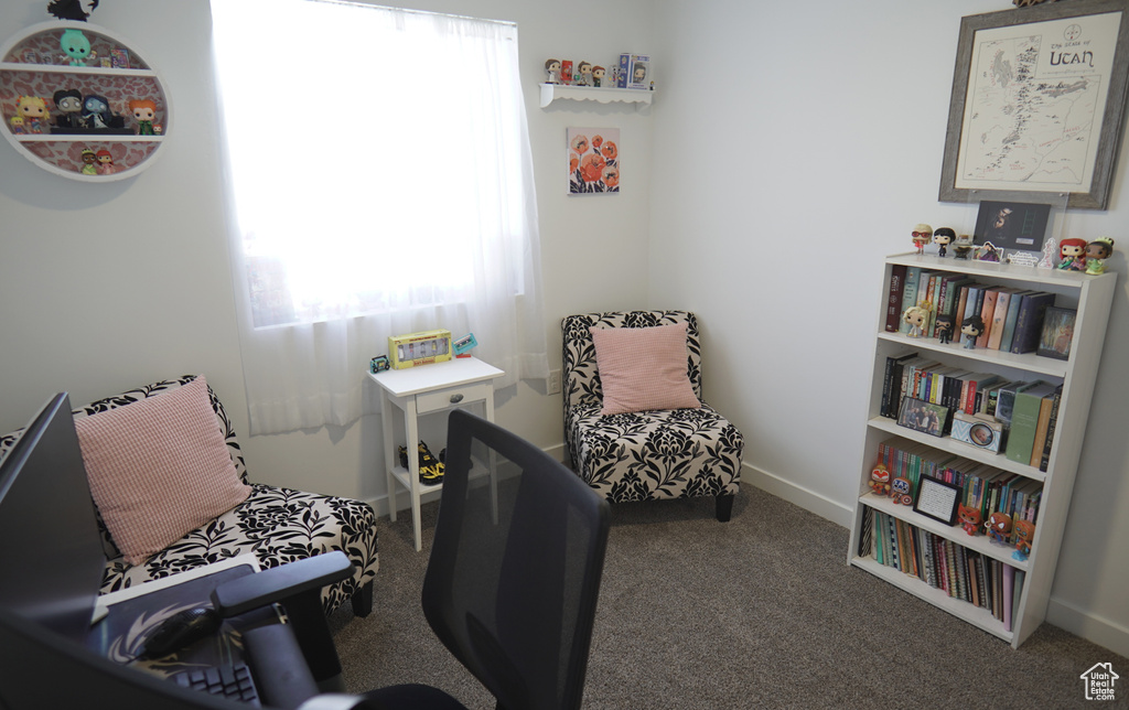 Living area with carpet flooring and baseboards