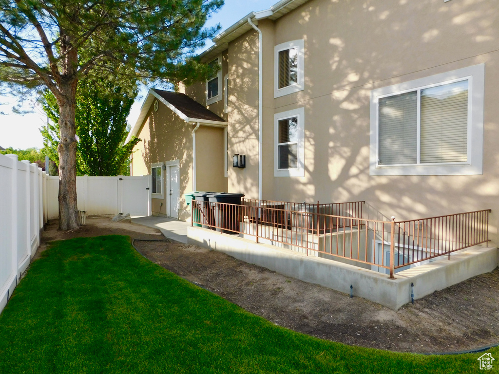 Rear view of house featuring stucco siding