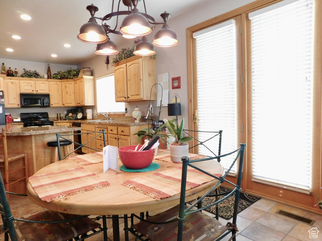 Dining area with recessed lighting and light tile patterned floors