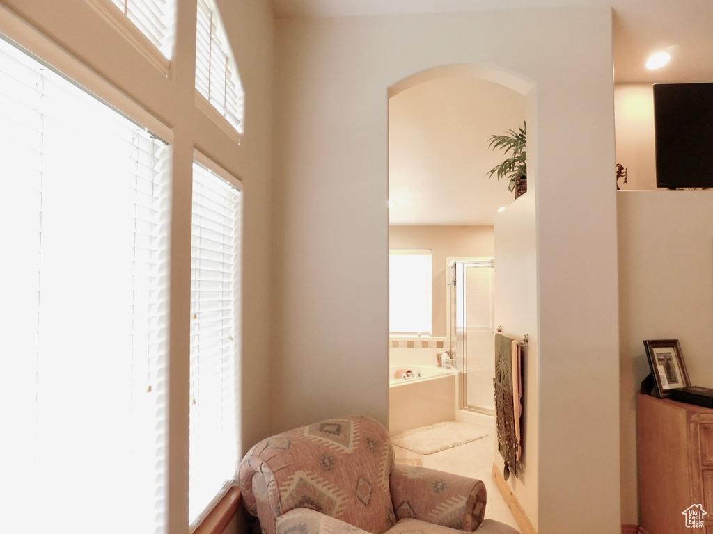 Sitting room featuring plenty of natural light and arched walkways