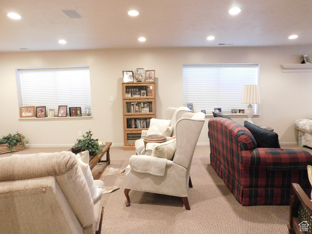 Living area featuring recessed lighting, light carpet, healthy amount of natural light, and baseboards