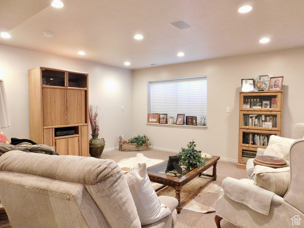 Living room featuring light colored carpet, recessed lighting, and baseboards