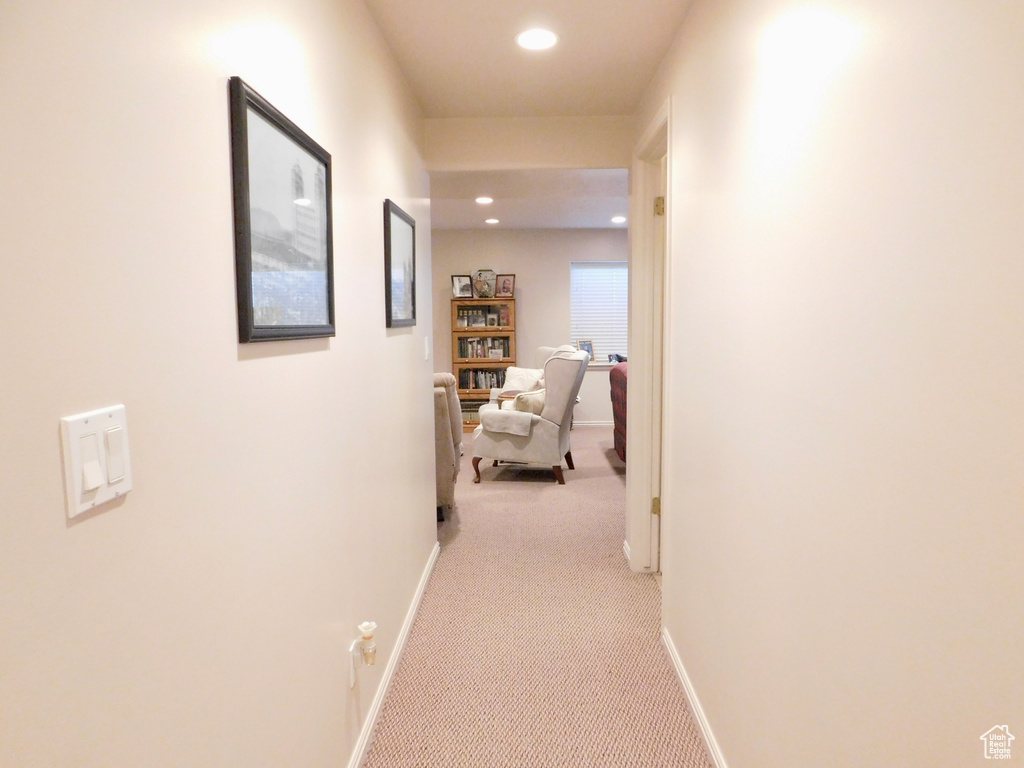 Corridor with light colored carpet, baseboards, and recessed lighting