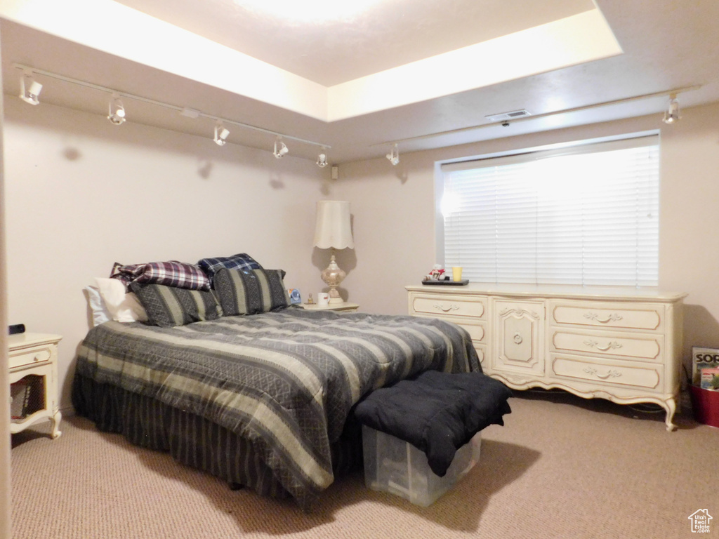 Bedroom featuring light colored carpet