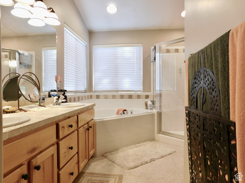 Full bathroom with a bath, a shower stall, double vanity, and recessed lighting