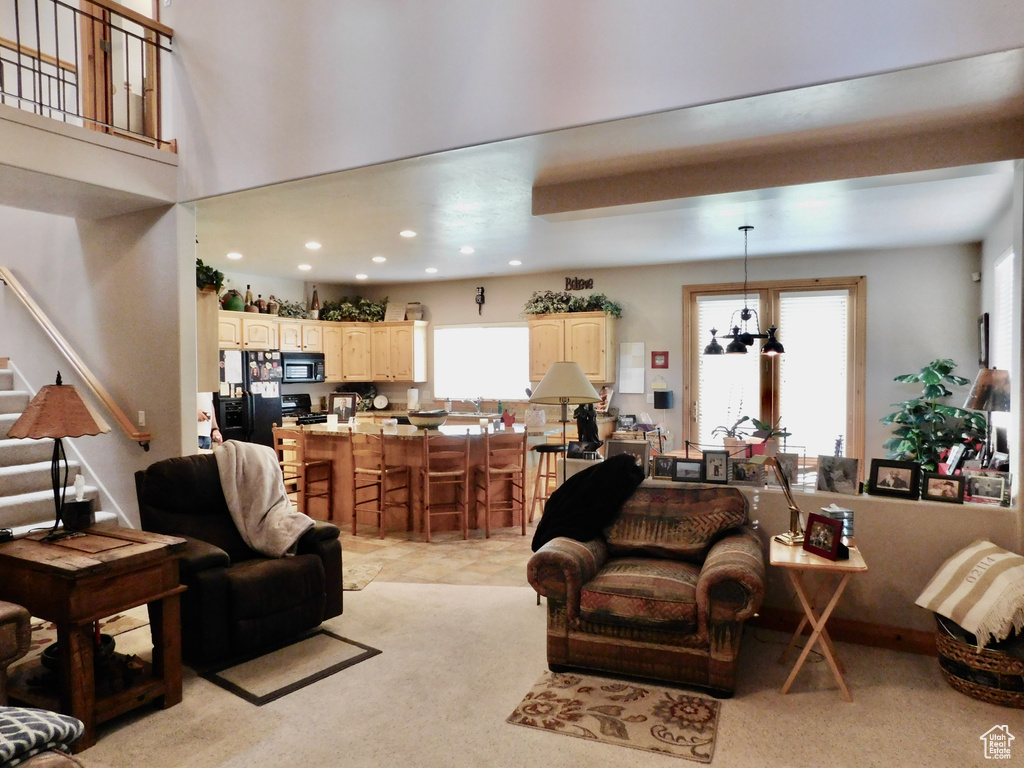 Living room featuring stairway, recessed lighting, and light colored carpet