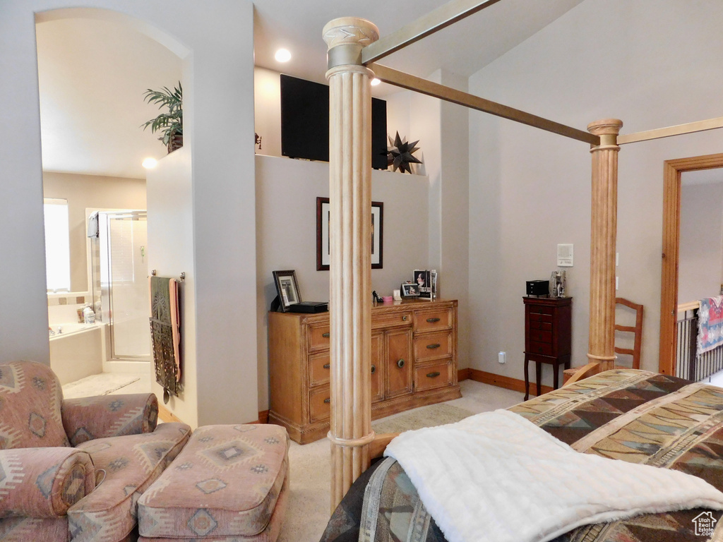 Bedroom featuring light colored carpet and ornate columns