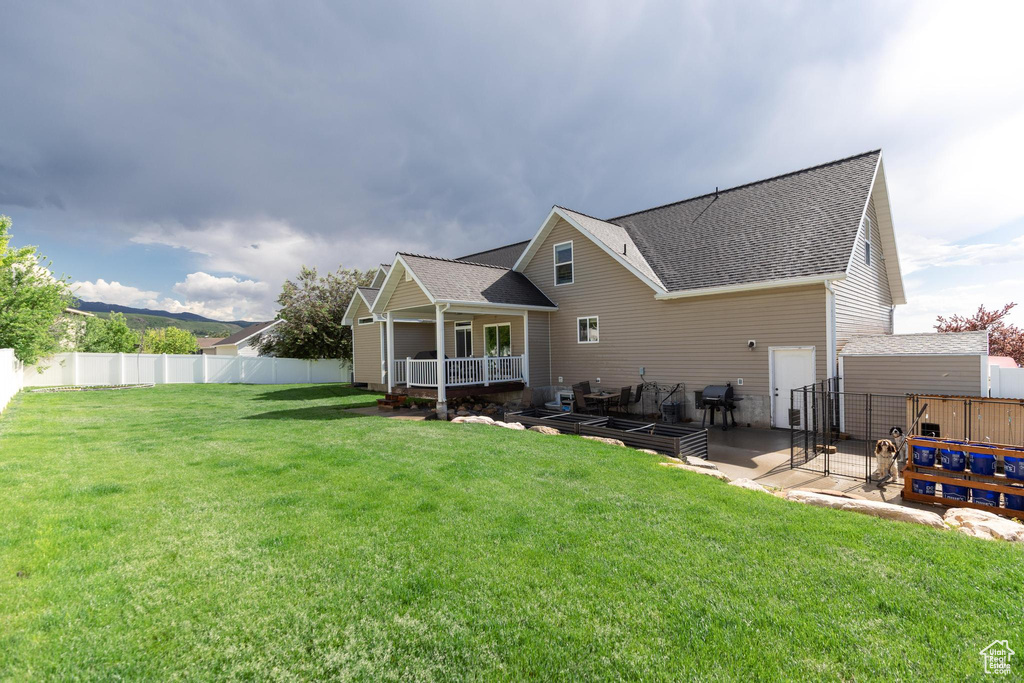 Back of property featuring a shingled roof