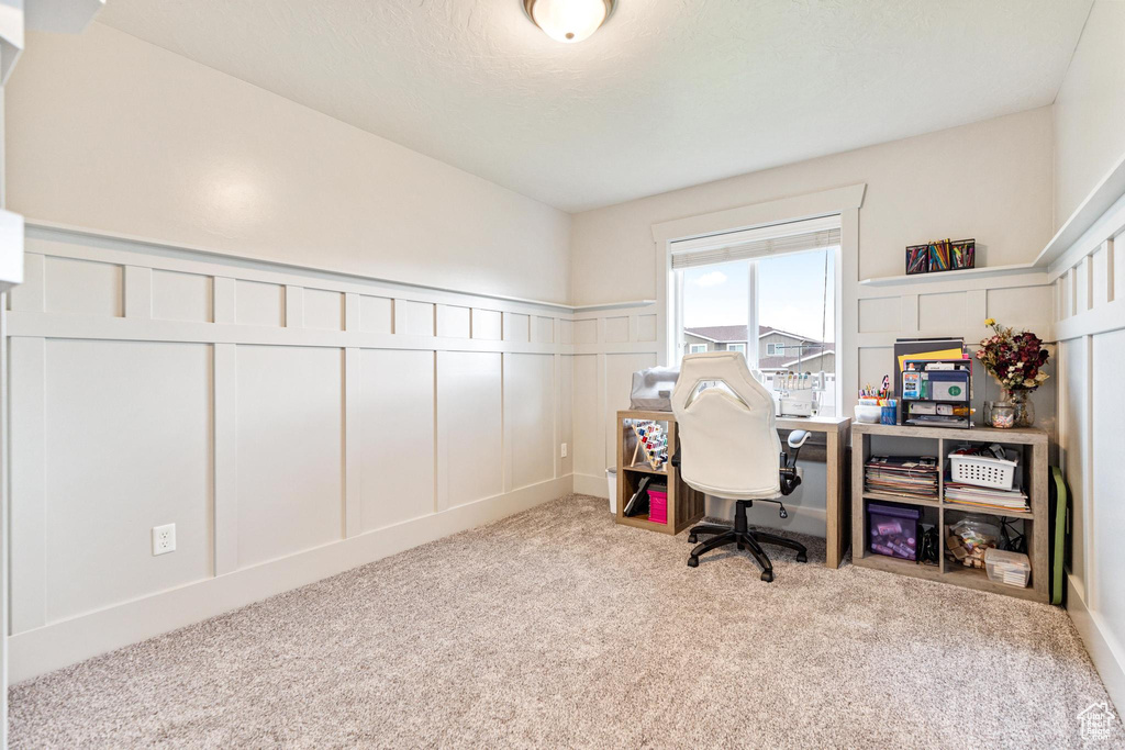 Carpeted office with a decorative wall and a wainscoted wall
