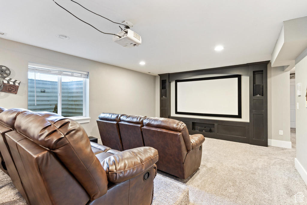 Carpeted home theater room featuring recessed lighting and baseboards